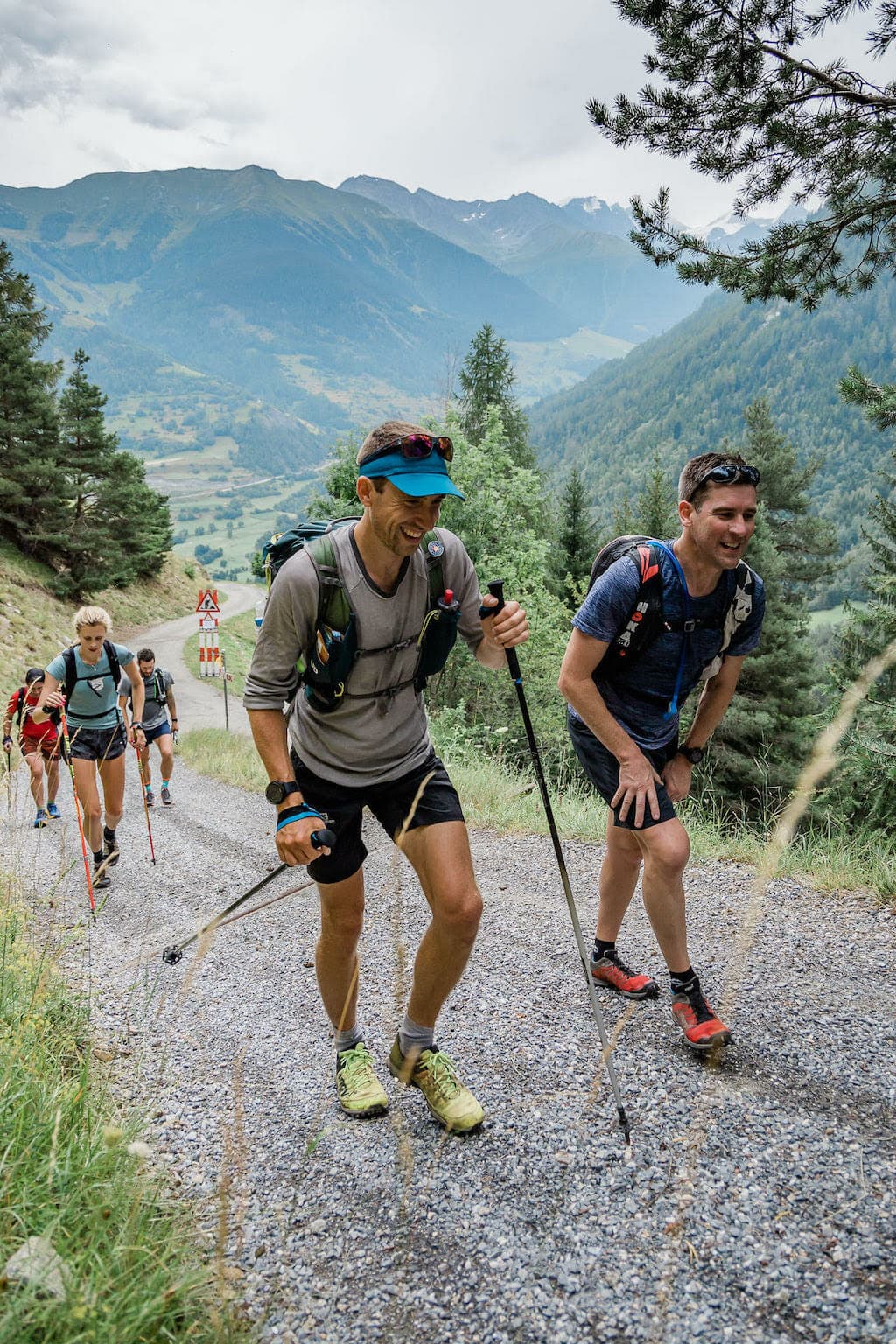 Sam Hill with his group walking uphill on a gravel road