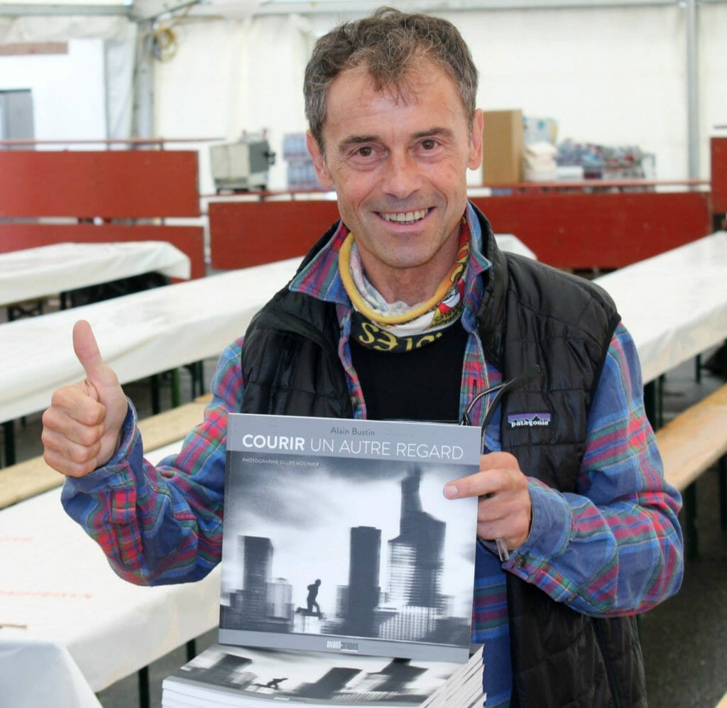 Signing copies of Courier Un Autre Regard. (Photo courtesy of Alain Bustin.)