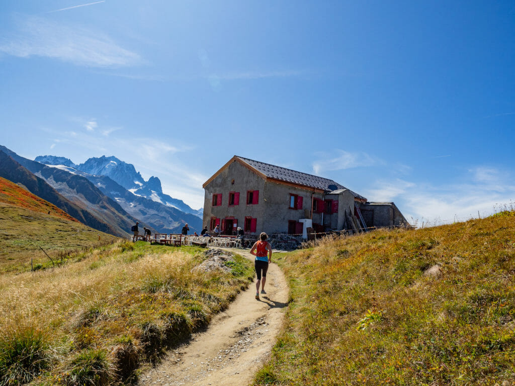 Female trail runner reaching the Refuge du Col de Balme