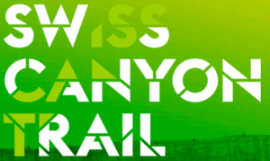 Green and white logo of Swiss Canyon Trail