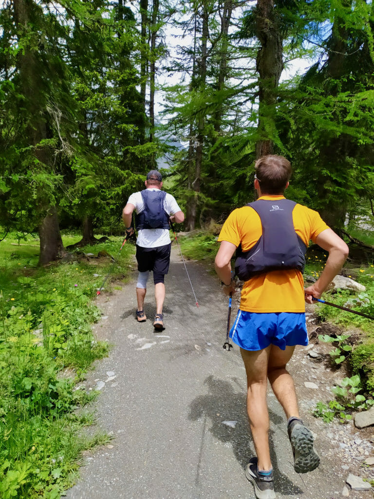 Two runners running through a forest.