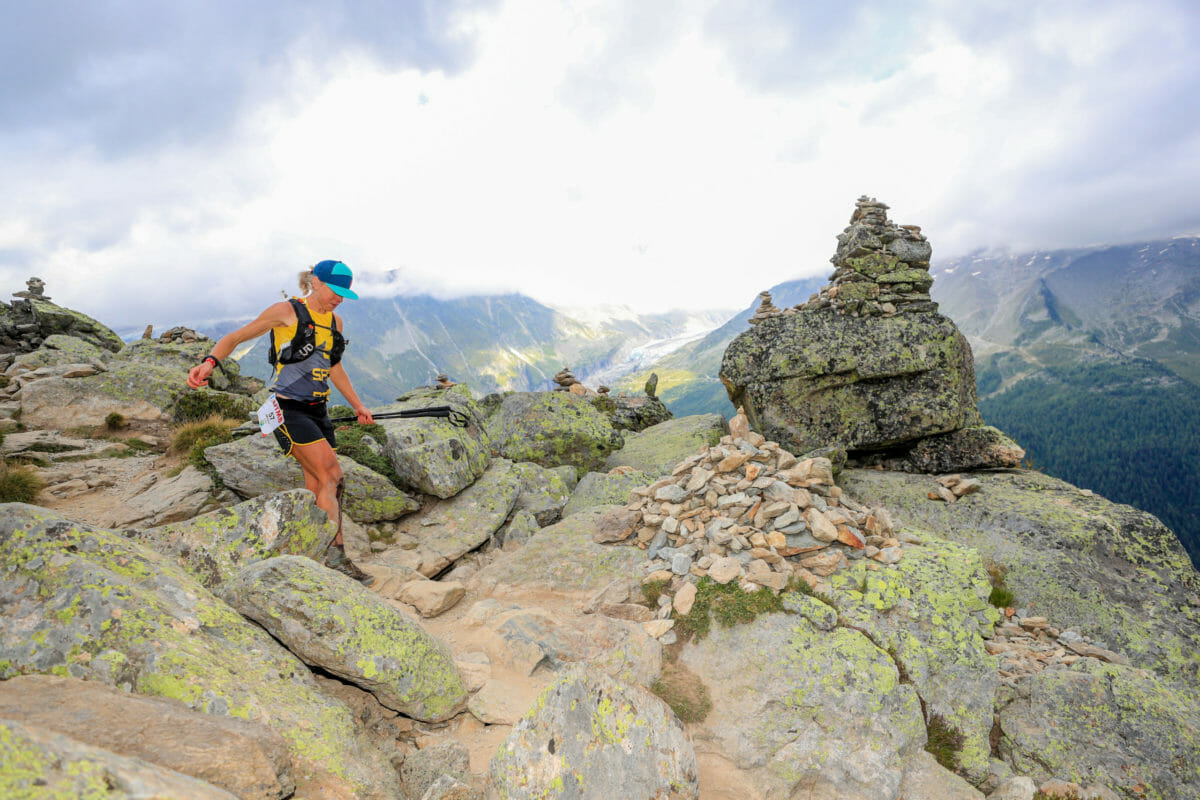 Female trailrunner with big cairn