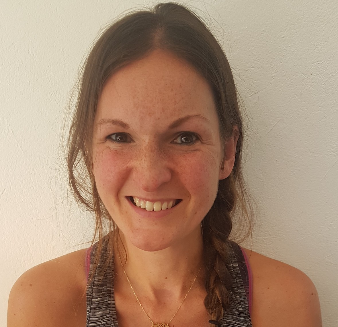 A woman with brown hair, seen face on in a headshot style photo
