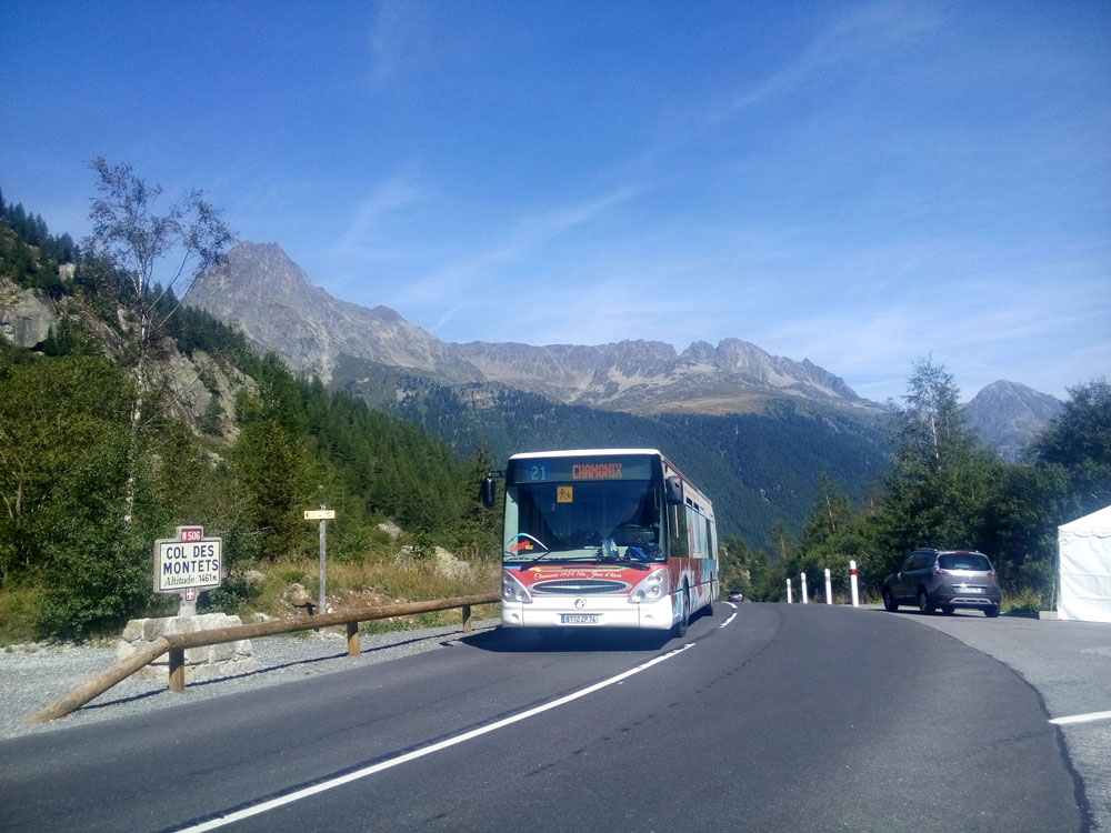 Bus on a highway with mountains.