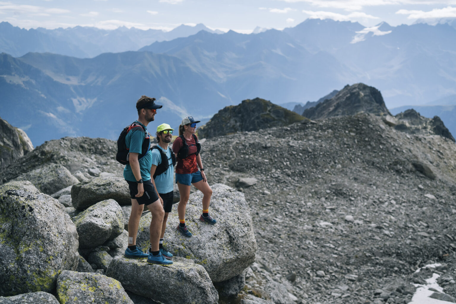 3 runners stop on rocks to look at the view