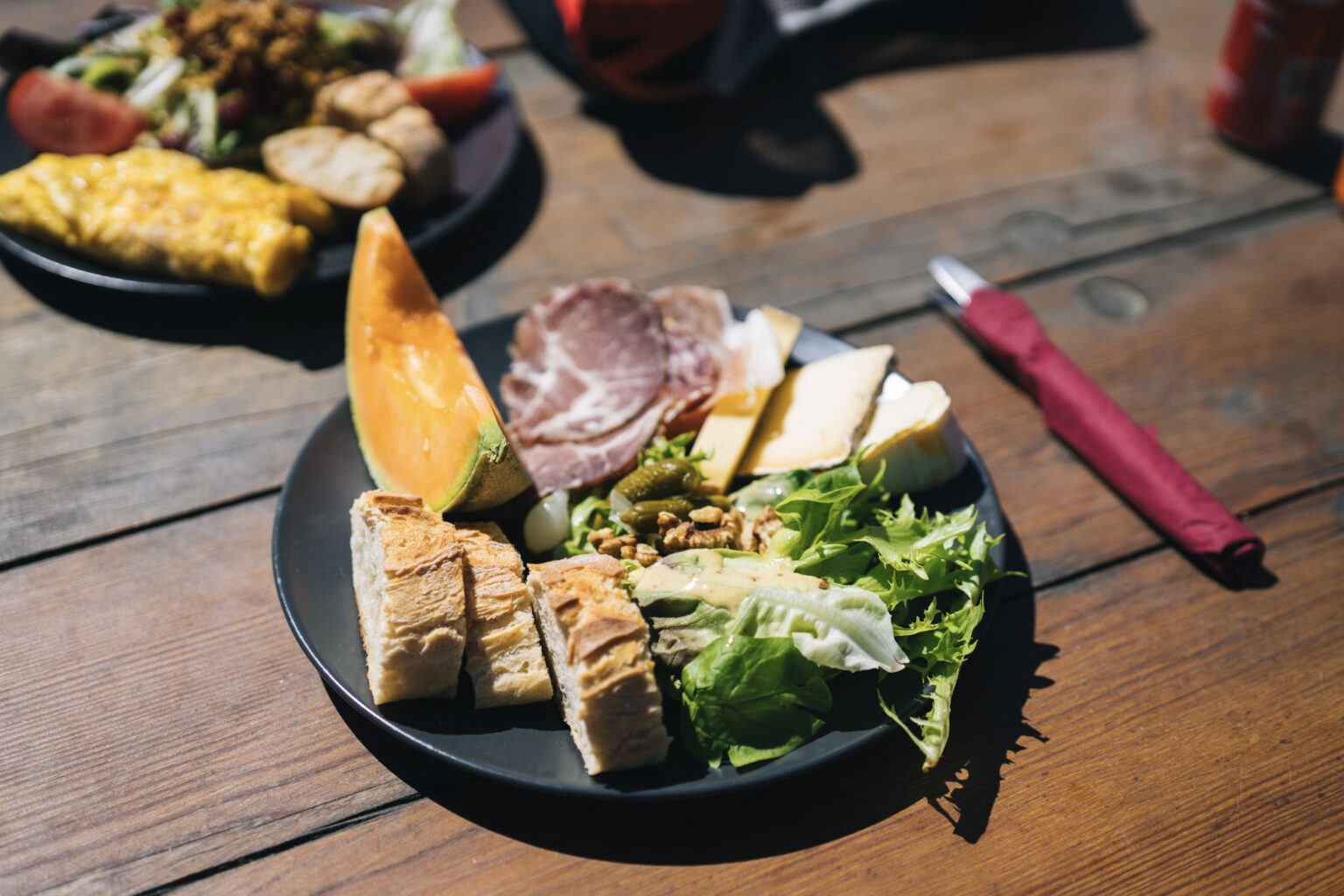 mountain refuge food - salad, meat, bread, fruit