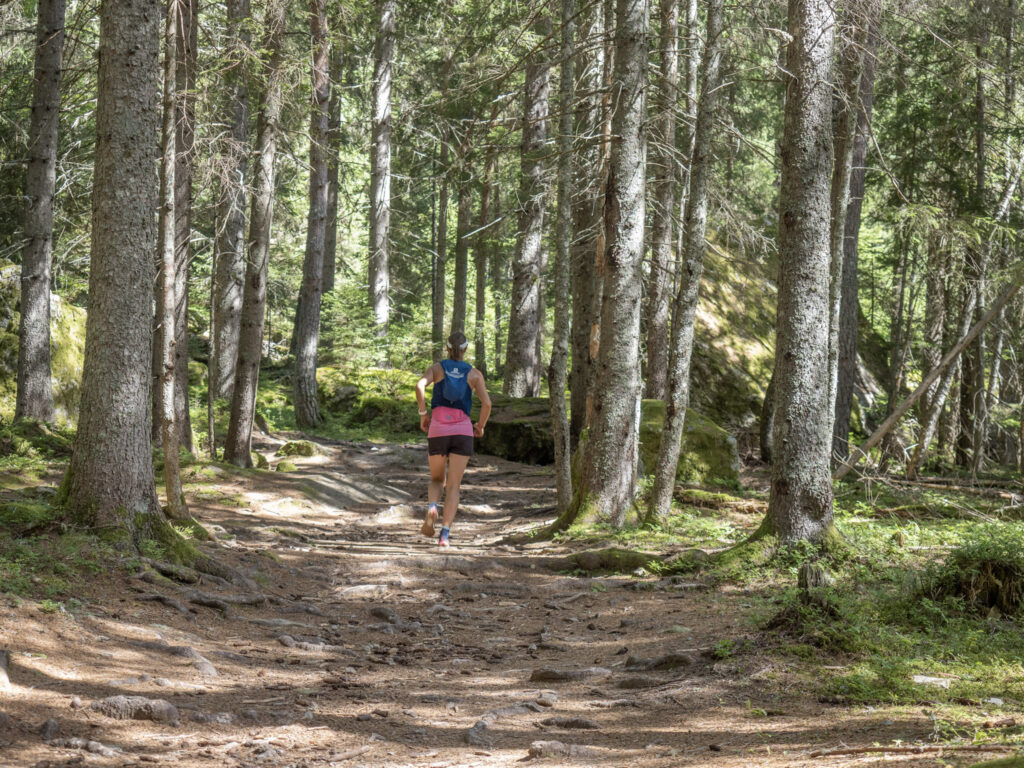Runner runs up Hill in Forest