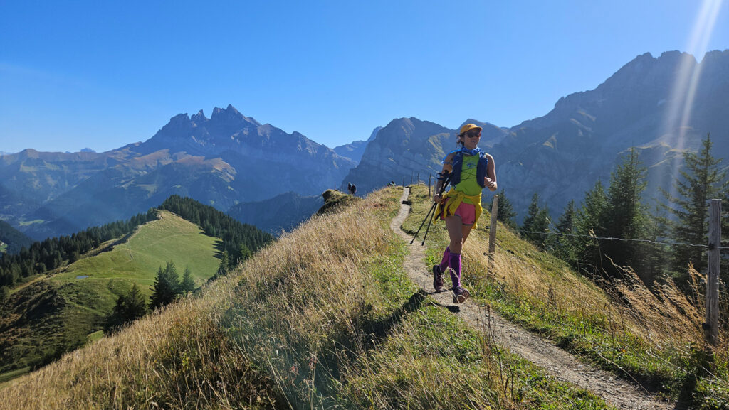woman in bright clothes running above Champéry, Switzerland
