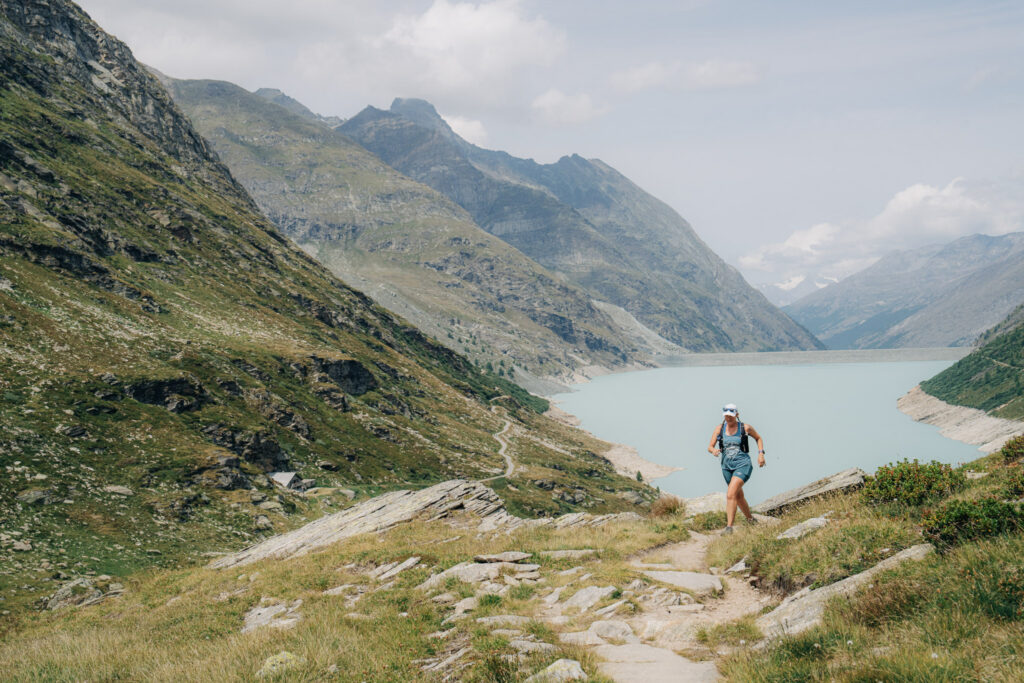 woman runner in blue shorts by lake