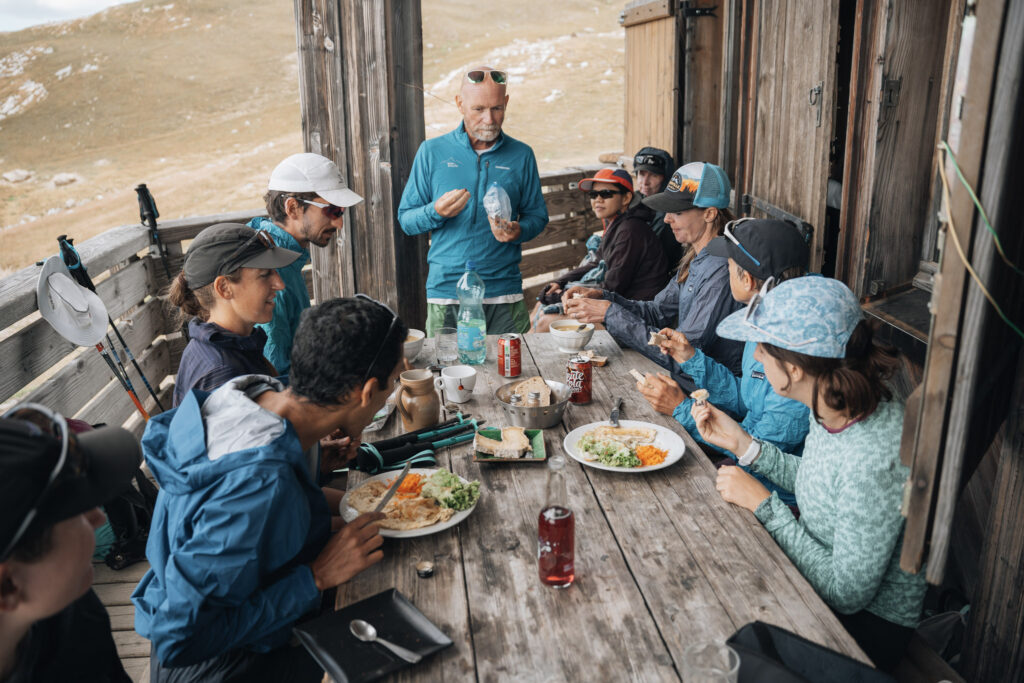 tour group eating lunch at a rustic hut