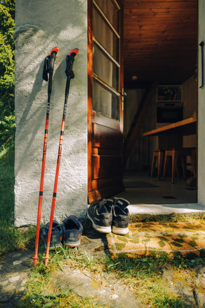 running shoes and poles outside a doorway