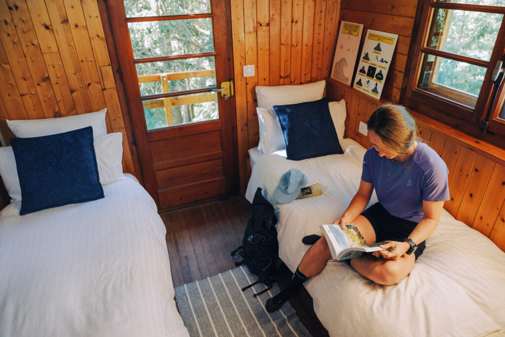 woman with a guidebook on a bed
