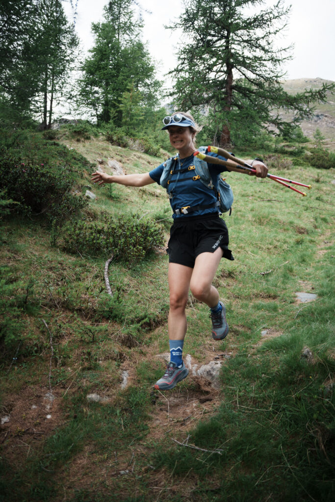 smiling runner carrying poles