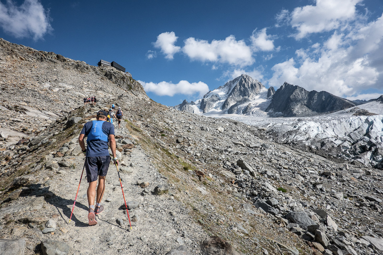 hiker with poles going up to Refuge Albert 1er