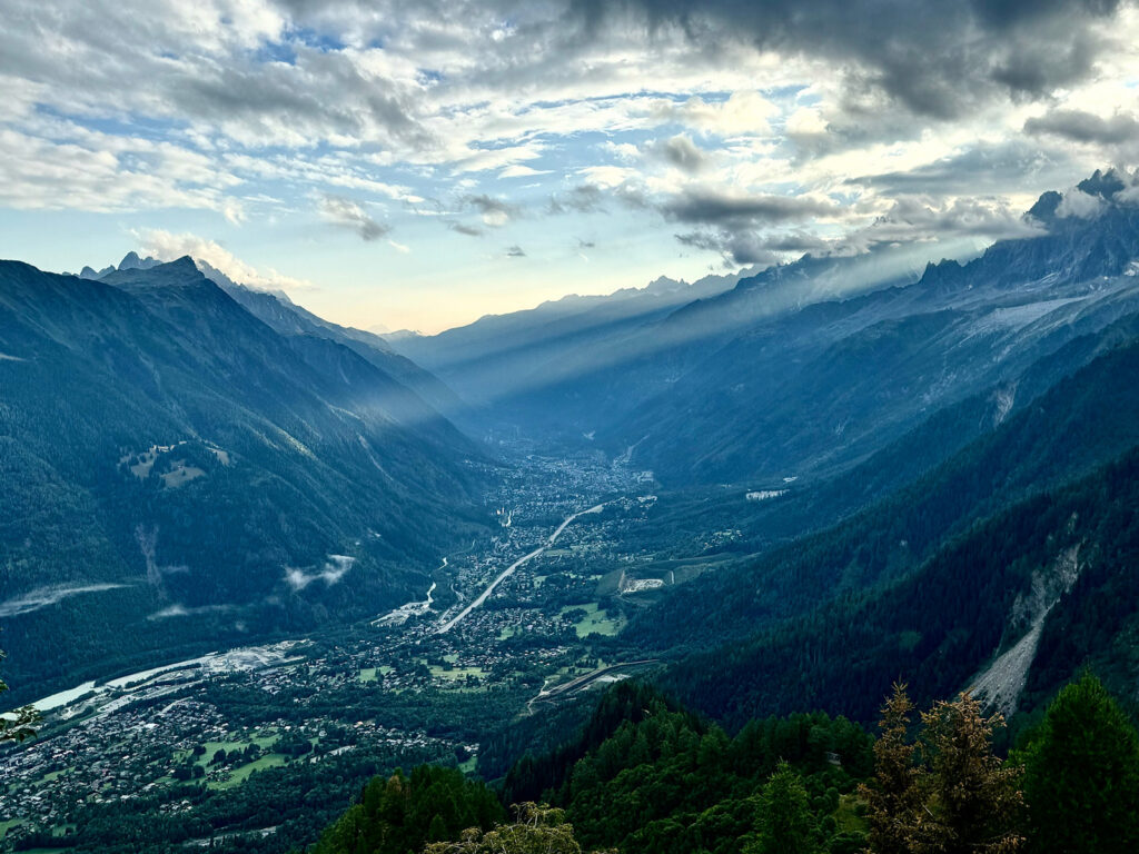 view onto Chamonix with light streaming through clouds
