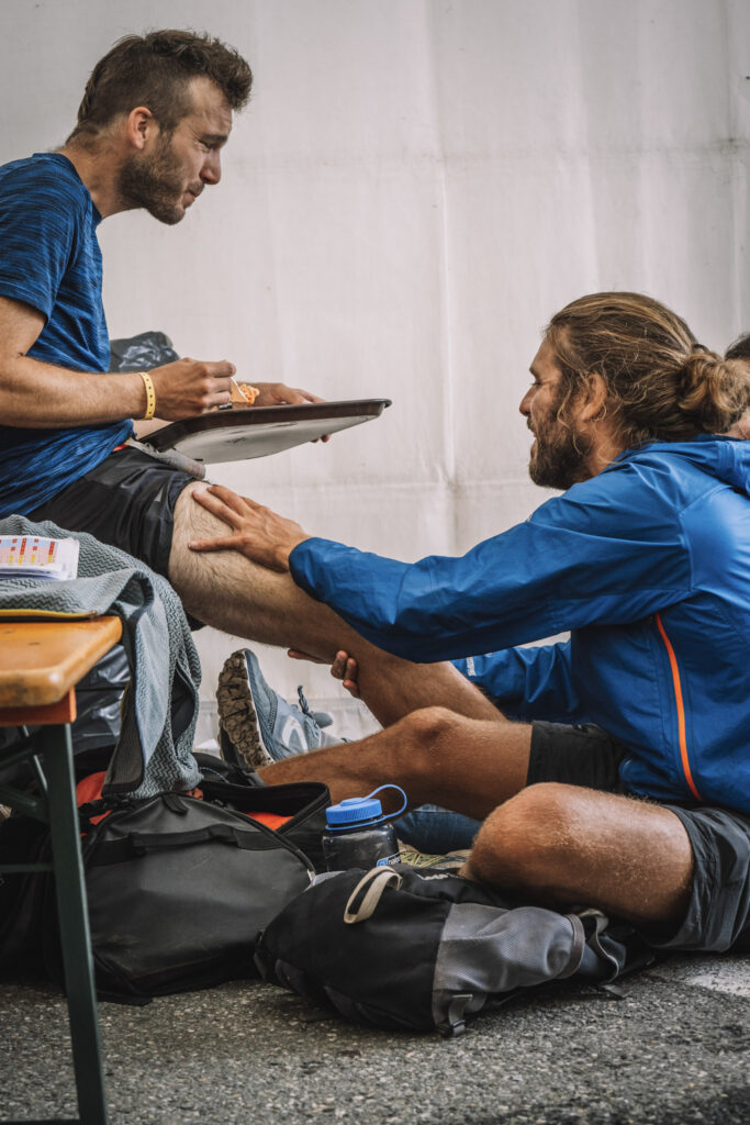 two men eating and massaging during Tor